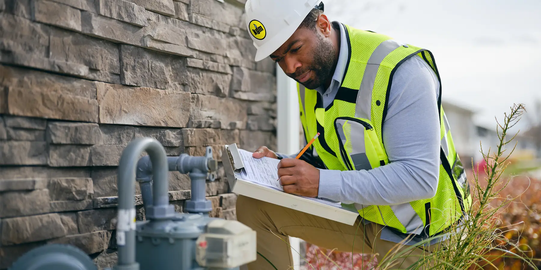 Gas worker inspecting meter