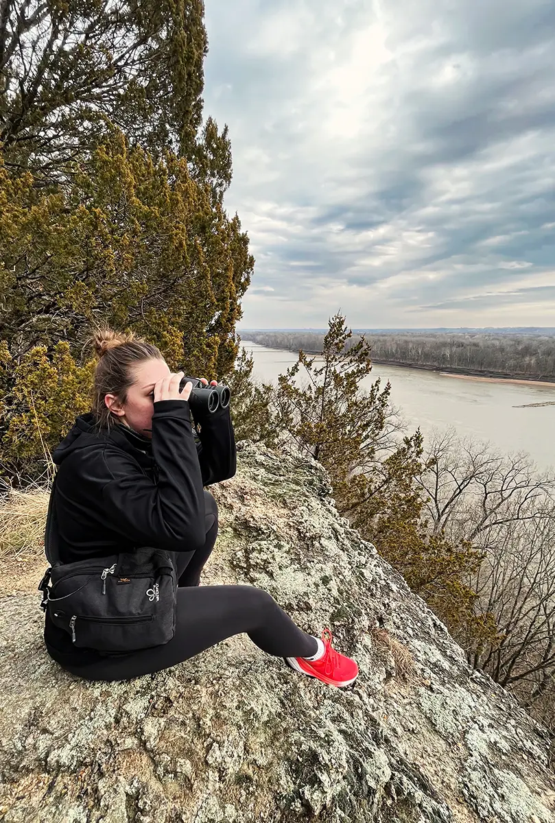 Maddie hiking over river