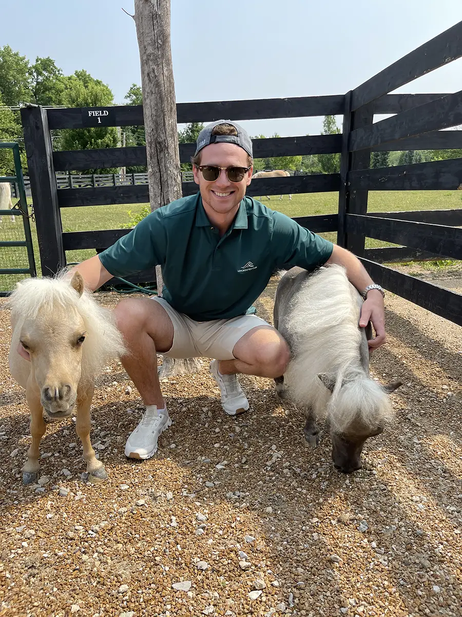 Mason Oberg with horses on farm