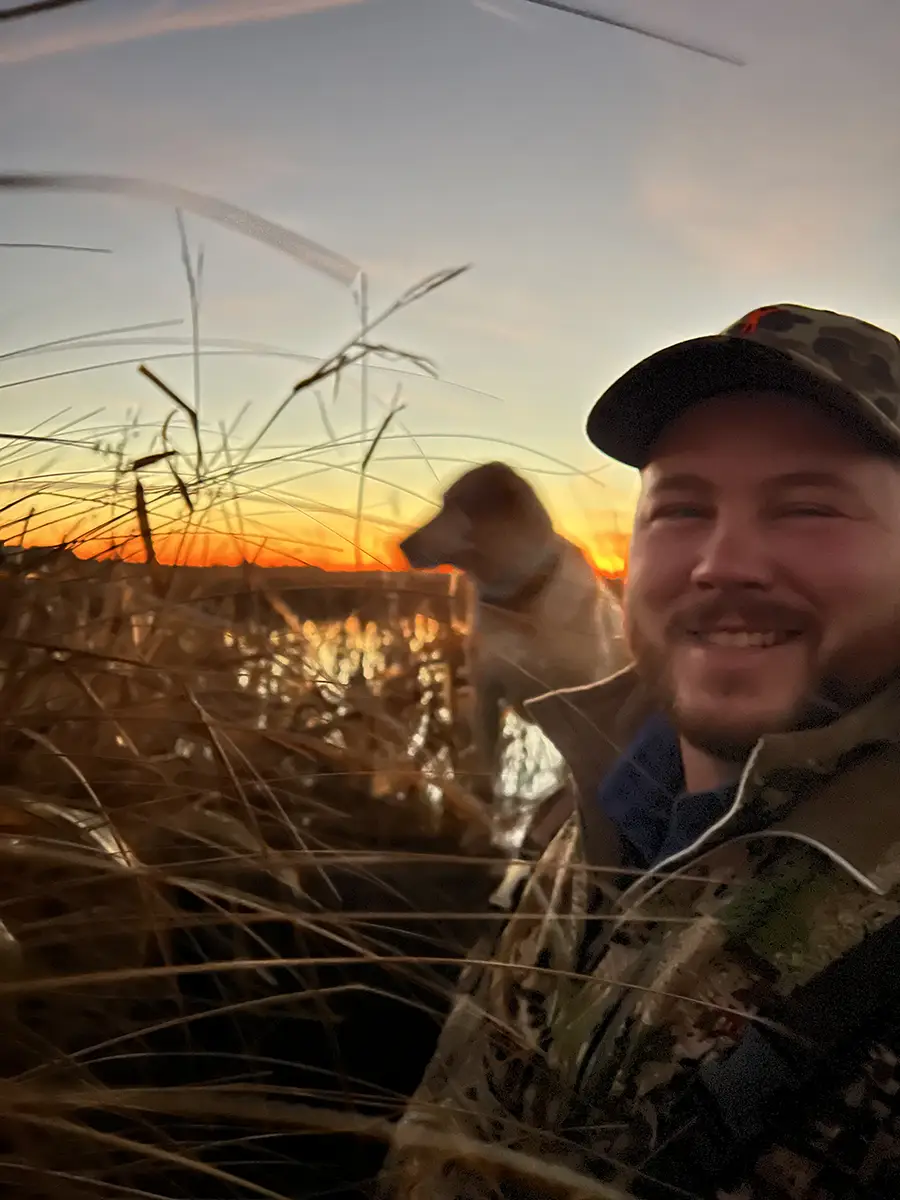 hunting with dog at sunset