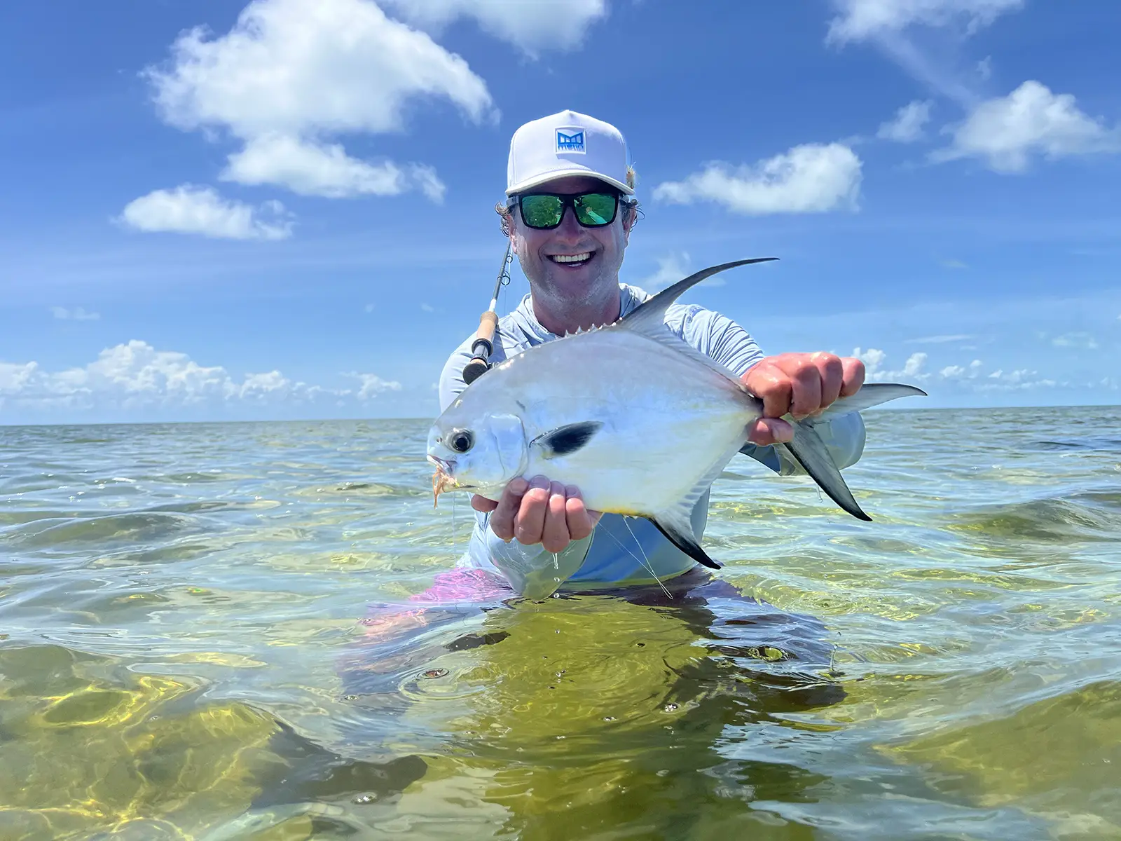 Stu holding fish in ocean